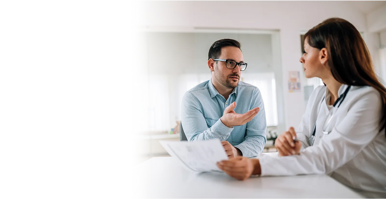 Image of doctor and patient or caregiver discussing diagnosis questions with their provider